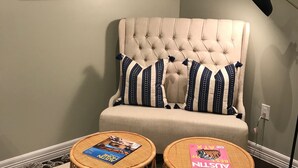 A room with a tufted sofa, two wicker side tables, and three framed artworks on the wall. - Carriage House in Tarrytown - Central Austin, New in 2018 (Austin)