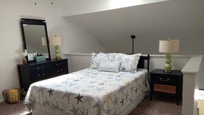 A bedroom with a bed, two nightstands, a dresser, a mirror, and a window. - COMPLETELY RENOVATED! Immaculately clean and new. See new photos! (Surfside Beach)