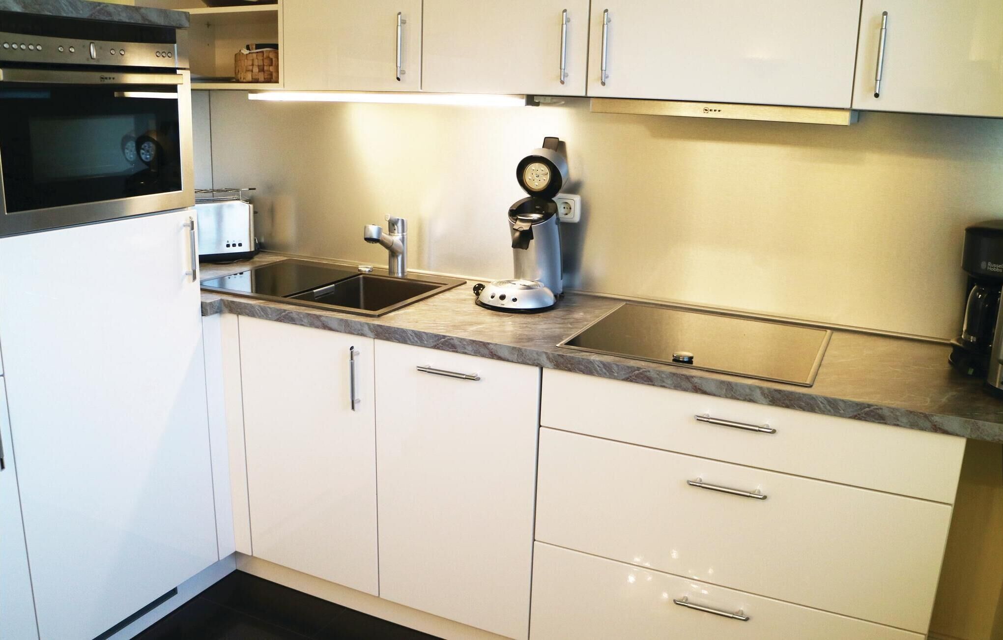 Fridge, stovetop, dishwasher, coffee/tea maker