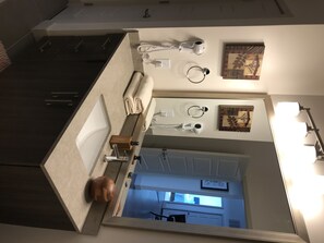 Bathroom features a sink, towel rack, and hairdryer.