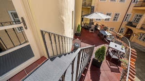 A courtyard with outdoor seating, a staircase, and a view of adjacent buildings. - OLD TOWN - STUDIO MICHALSKA max 4 pers (Prague 1)