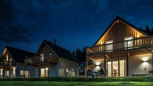 A row of wooden cabins with balconies, under a starry night sky. - HOUSE ON THE LAKE WITH DIRECT ACCESS TO THE LAKE (Frymburk nad Vltavou)