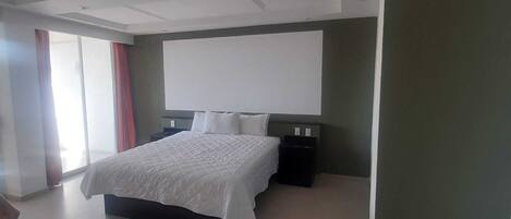 A modern bedroom with a large bed, a flat-screen TV, and a nightstand.