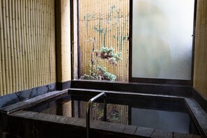 A traditional Japanese-style room with tatami flooring, a shoji screen, and a small indoor garden with a bonsai tree. - GUEST HOUSE MASAGO - Hostel (Urakawa)