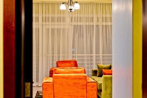 Family Apartment, 2 Bedrooms, Accessible, Hill View | Living area | Flat-screen TV - Greendale Apartments (Kampala)