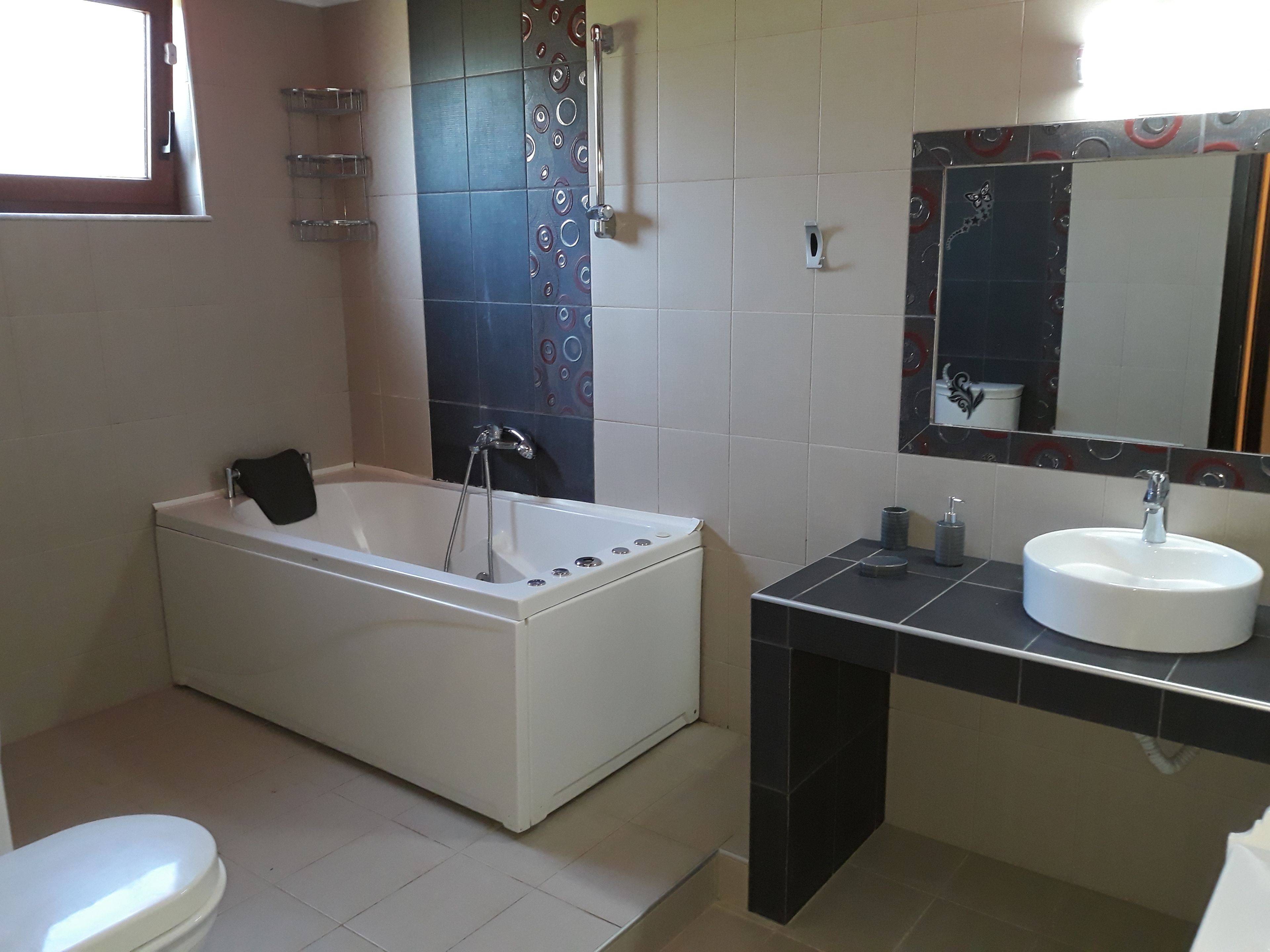 A bathroom with a bathtub, a sink, and a toilet.