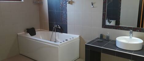A bathroom with a bathtub, a sink, and a toilet.