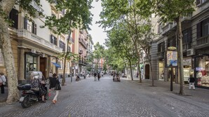A cobblestone street lined with multi-story buildings, some with balconies and storefronts. - The Andy House B&B (Naples)