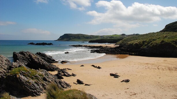 A coastal beach with rocky outcrops and a sandy shore. - McGrorys (Culdaff)