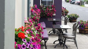 A restaurant named McGrory's with outdoor seating and flower arrangements. - McGrorys (Culdaff)