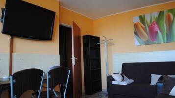 Apartment, Sea View | Living area | 40-inch flat-screen TV with cable channels, TV