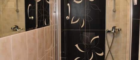 Apartment, Sea View | Bathroom | Shower, hair dryer, towels