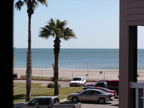 View of beach and sand from balcony of condo