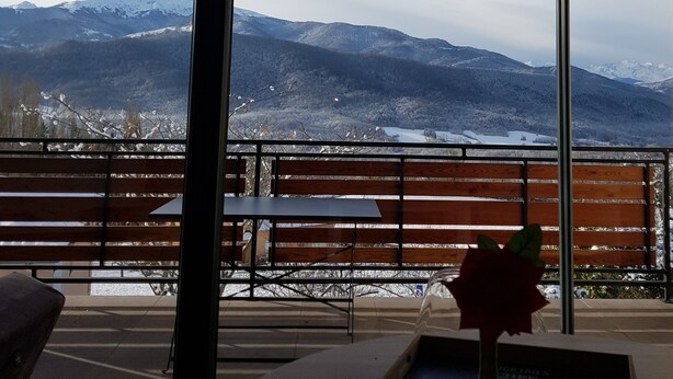 A room with a large window overlooking a snowy mountain landscape. - Superb entirely new housing (Leychert)