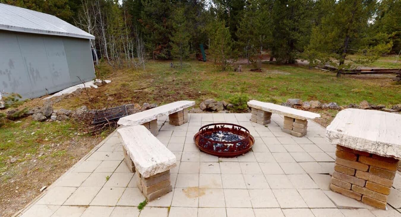 A patio area with stone benches and a fire pit.