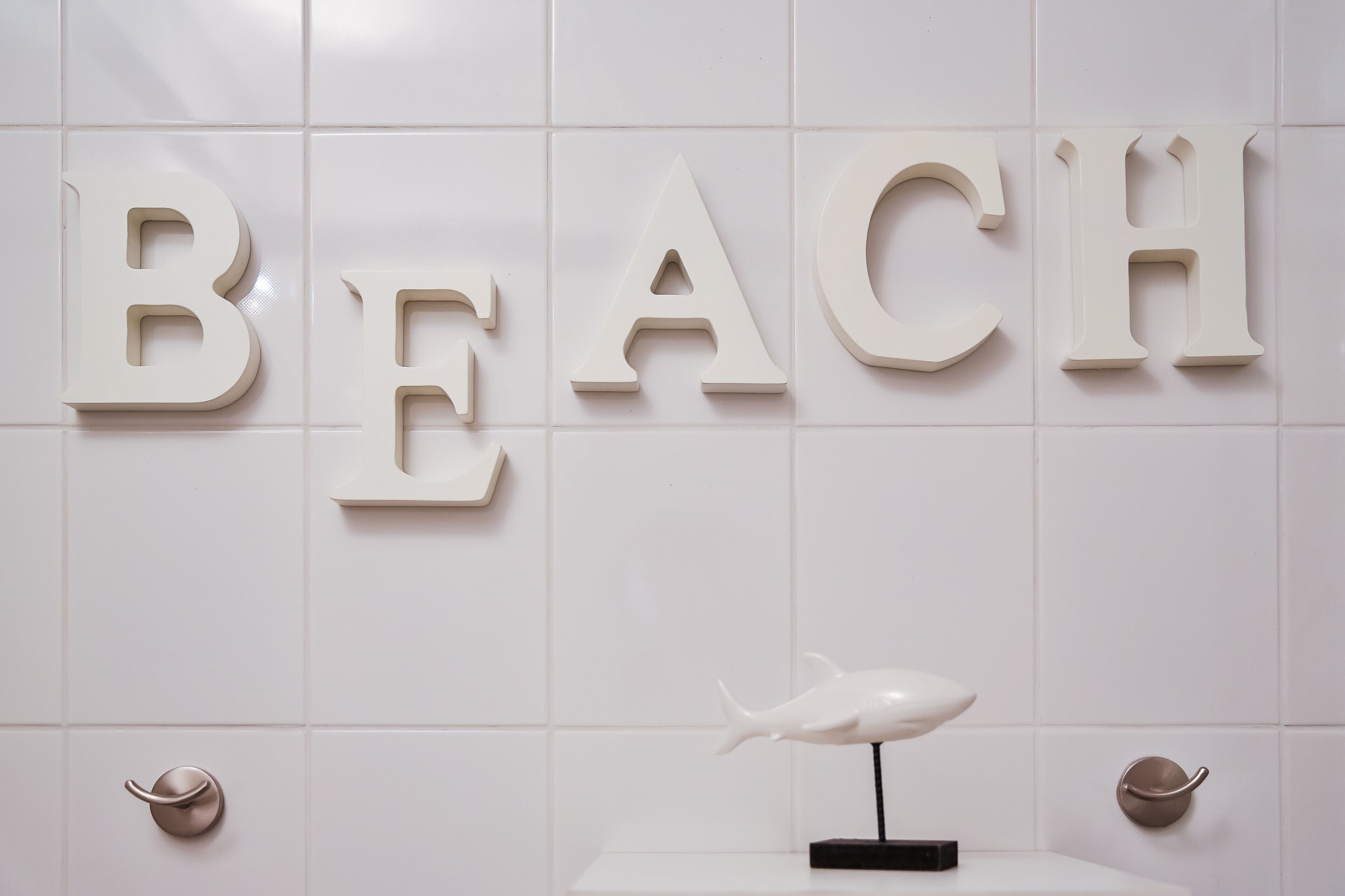 A wall with the word "BEACH" spelled out in large letters.