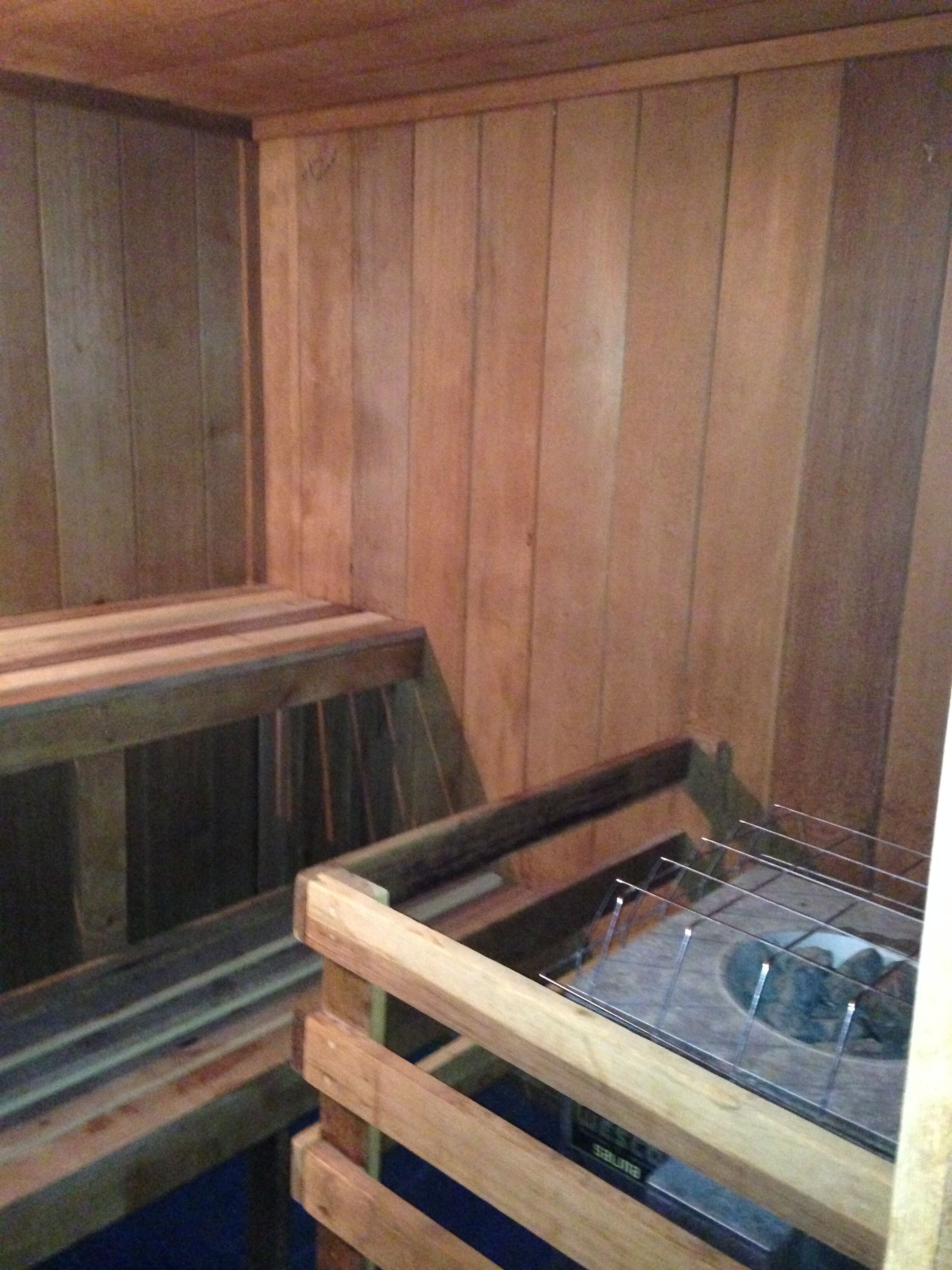 A sauna with wooden walls and benches.