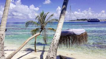 On the beach, white sand, sun-loungers