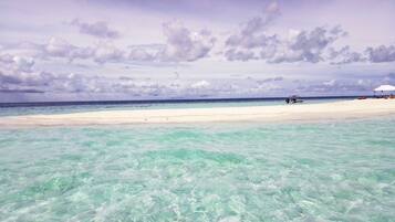 On the beach, white sand, sun-loungers