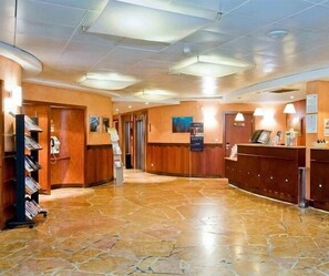 A lobby with a reception desk, a staircase, and a wall-mounted information board. - SUPERB 2 ROOMS - PARIS LA DEFENSE- RESIDENCE 4* (Courbevoie)