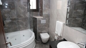 A modern bathroom with a freestanding bathtub, a toilet, and a sink. - Paris Prestige (Izmir)
