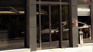 The entrance of Hotel Paris Prestige with large glass doors and a prominent sign above. - Paris Prestige (Izmir)
