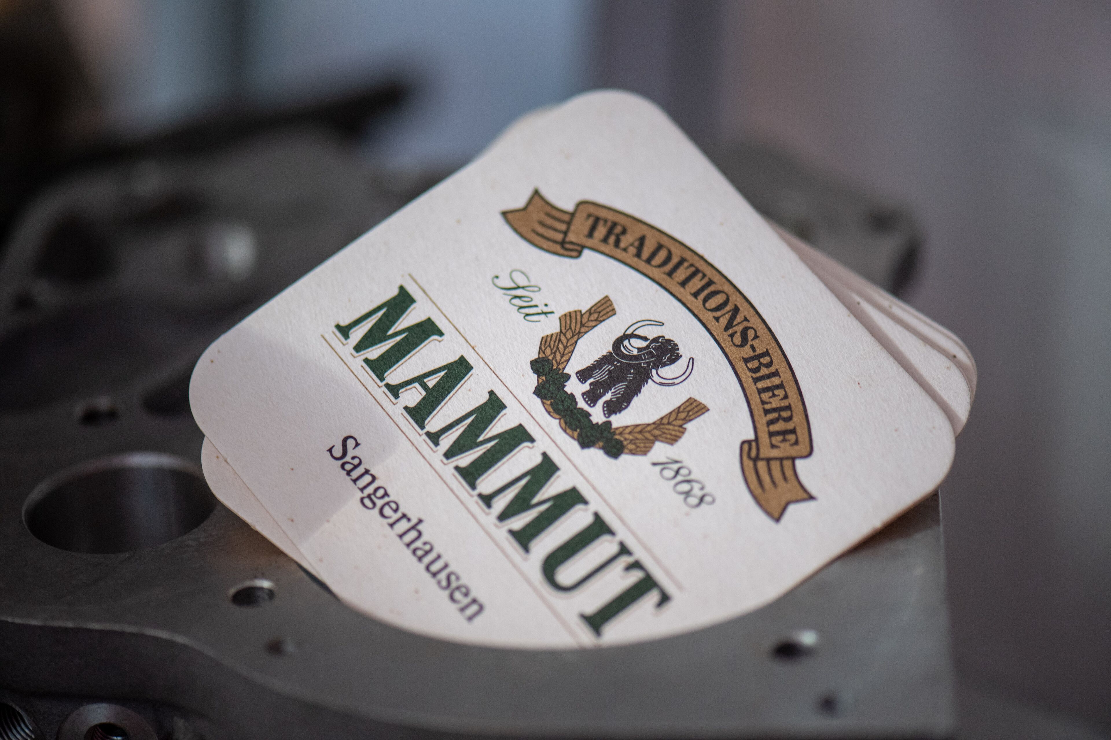 A metal surface with a label that reads "Traditions-HER" and "MAMMUT" along with "Sangerhausen" and "1868".