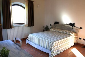 Un dormitorio con cama, escritorio y silla.