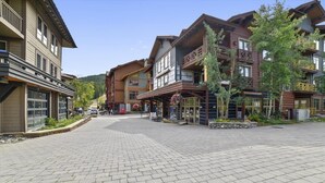 A paved square with buildings on either side, featuring balconies and large windows. - Tucker Mountain Lodge 102 2 Bedroom Condo by RedAwning (Copper Mountain)
