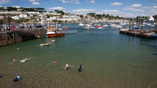 A coastal marina with boats, a pier, and people swimming in the water. - Cuckoo Tor - Two Bedroom Cottage, Sleeps 4 (Lanteglos)