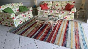 A living room with two sofas, a coffee table, and a striped rug. - South Shores I 3 2 Bedroom Condo by RedAwning (Surfside Beach)