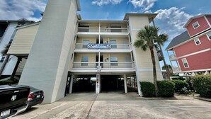 A multi-story hotel with a sign reading "South Shores" and a parking area in front. - South Shores I 3 2 Bedroom Condo by RedAwning (Surfside Beach)