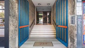 A staircase leading to a door with the number 259 on the mat.