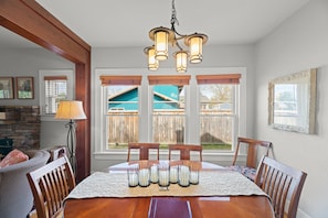 Enjoy meals with family and friends in this spacious dining area, complete with a large wooden table and comfortable chairs.