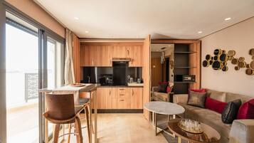 Deluxe Suite | Living area | 109-cm TV with digital channels