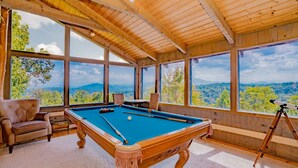 A pool table with a clear view of the outdoors through large windows. - 🐻Beau Voir🚡 Beautiful Views, Game Loft, Great Location, & Hot Tub (Sevierville)