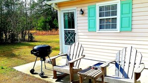 A house with a porch, outdoor seating, and a grill. - Lunas Flat  145 :Spotless, Sweet, Cozy & Comfy. Just renovated. (Aiken)