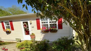 A white house with red shutters, numbered 145, and flower boxes on the windows. - Lunas Flat  145 :Spotless, Sweet, Cozy & Comfy. Just renovated. (Aiken)