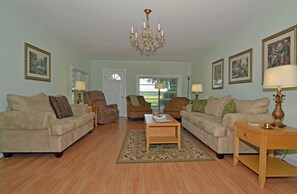 A living room with two sofas, a coffee table, and a chandelier. - Hi Speed Internet Lawrenceburg TN area, Outdoor Living Space, Wk/Month Discounts (Lawrenceburg)