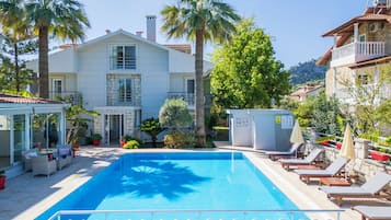 Seasonal outdoor pool, open 9:00 AM to 6:00 PM, pool umbrellas