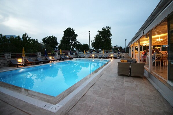 Seasonal outdoor pool, open 9:00 AM to 6:00 PM, pool umbrellas
