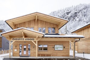 A wooden lodge with a sign reading "ZUGSPITZ LODGES". - Zugspitz Lodge (Ehrwald)
