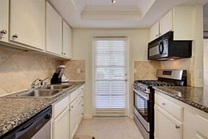 Condo, 2 Bedrooms | Private kitchen | Fridge, oven, coffee/tea maker, toaster