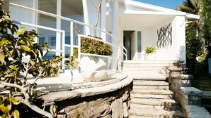 A modern house with a stone staircase leading to a white door. - Pacific Blue by Contemporary Hotels (PALM BEACH)
