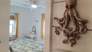 A room with a bed, a ceiling fan, and a wall-mounted octopus decoration. - VINTAGE BEACH COTTAGE
BOOK NOW! SAVE!!
90 sec. walk to beach!
Supplies Included! (North Myrtle Beach)
