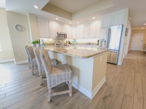 Fridge, microwave, oven, stovetop - Sandpiper's Cove 203  Luxury Coastal Living in Clearwater Beach (Clearwater Beach)