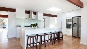 Fridge, stovetop, dishwasher, coffee/tea maker