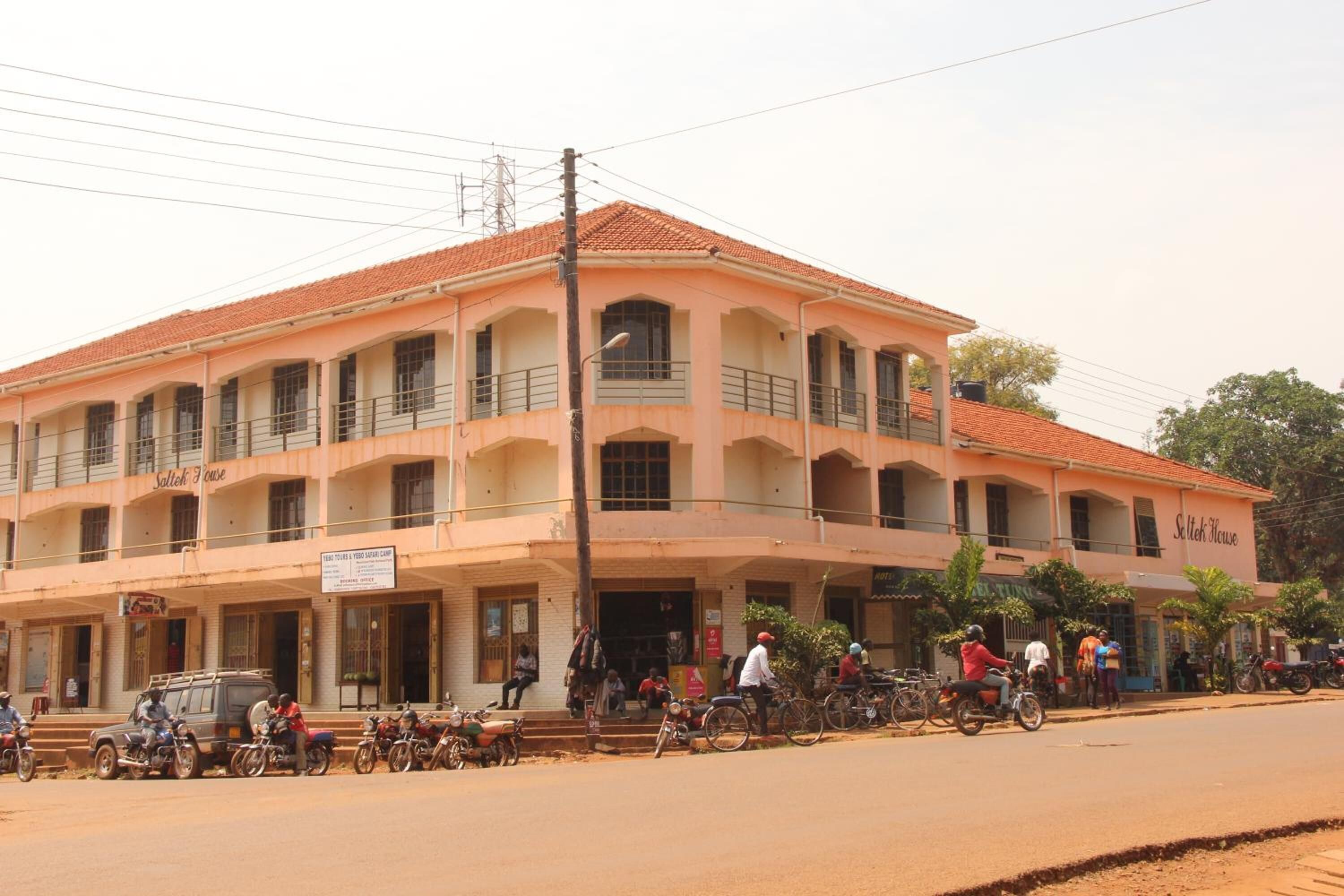 A multi-story building with a tiled roof, balconies, and a sign that reads "Selleh House."