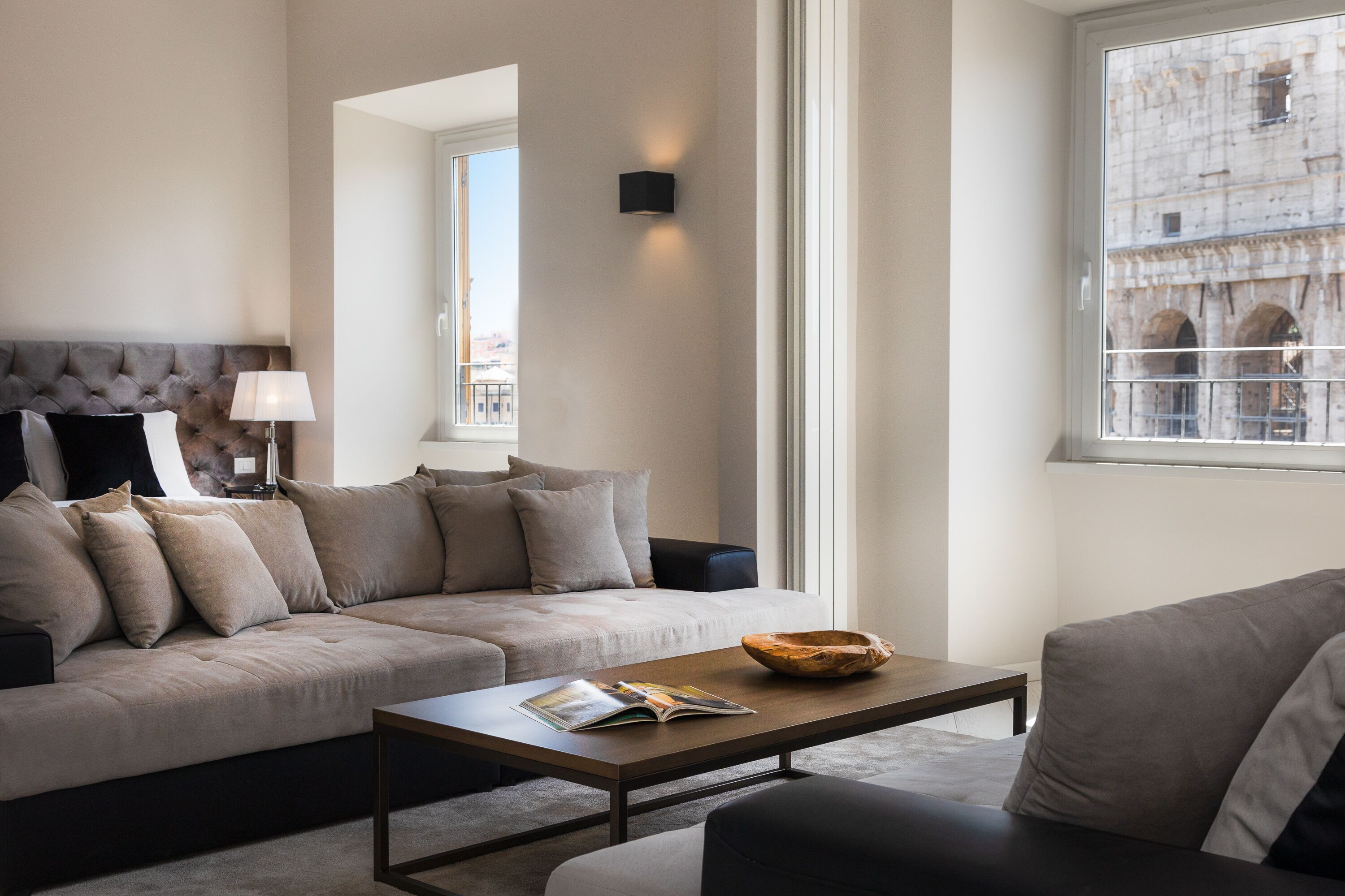 A modern living room with a sofa, a coffee table, and a lamp.