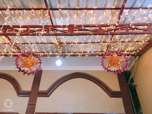 A ceiling with string lights and star-shaped decorations.